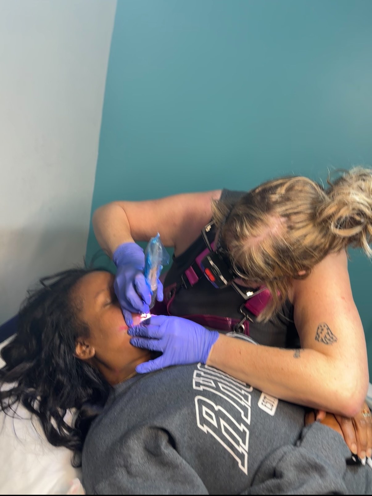 Kristin Lee performing a lip permanent makeup procedure