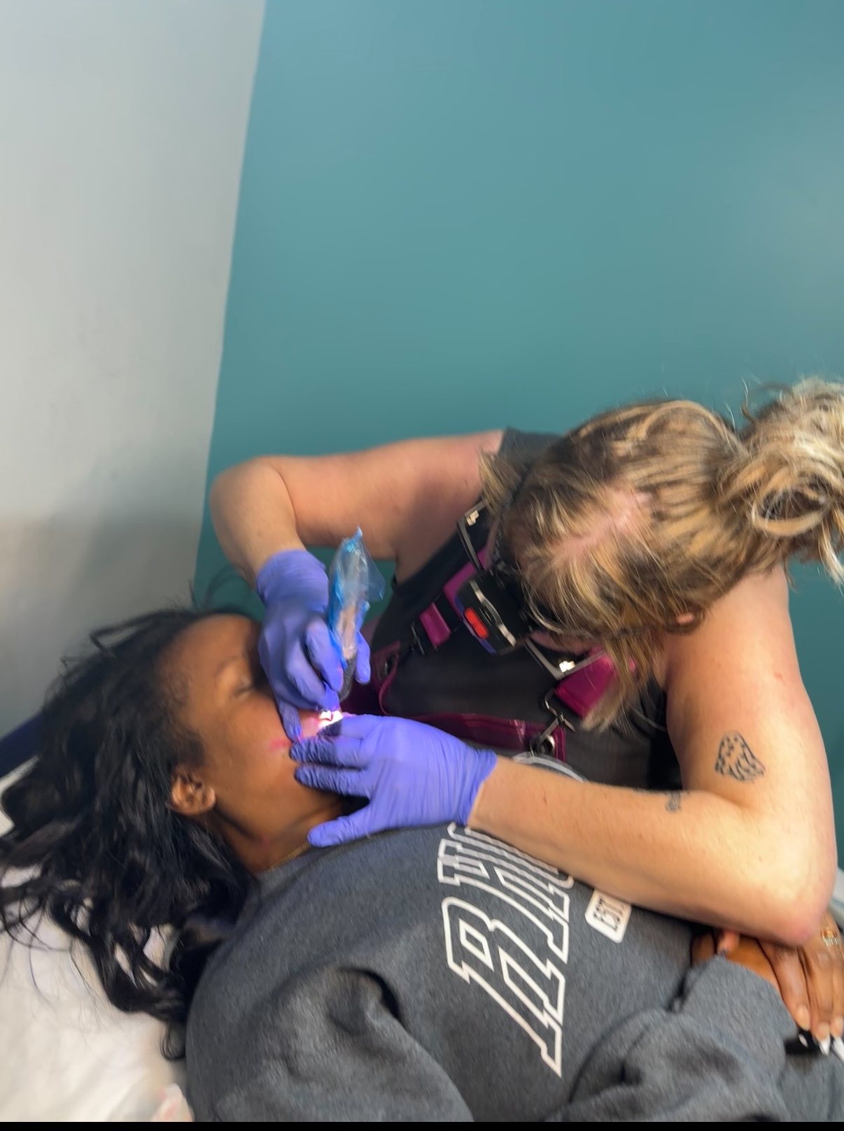 Applying lip permanent makeup pigment