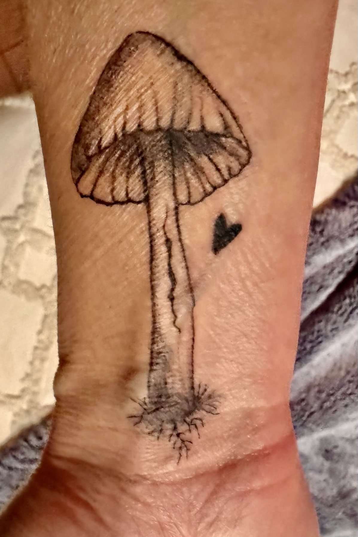 Fine line mushroom tattoo, black linework, healed